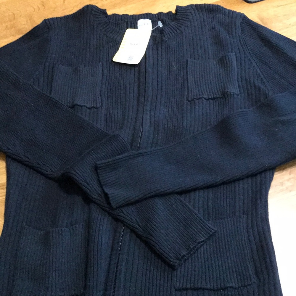 Black long sleeves sweater. Rib style with two pockets on top and two on bottom